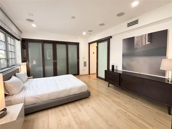 a bedroom with a bed and large window