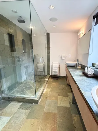 a spacious bathroom with a granite countertop sink mirror and a bath tub