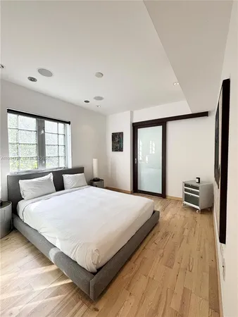 a spacious bedroom with a large bed and a large window