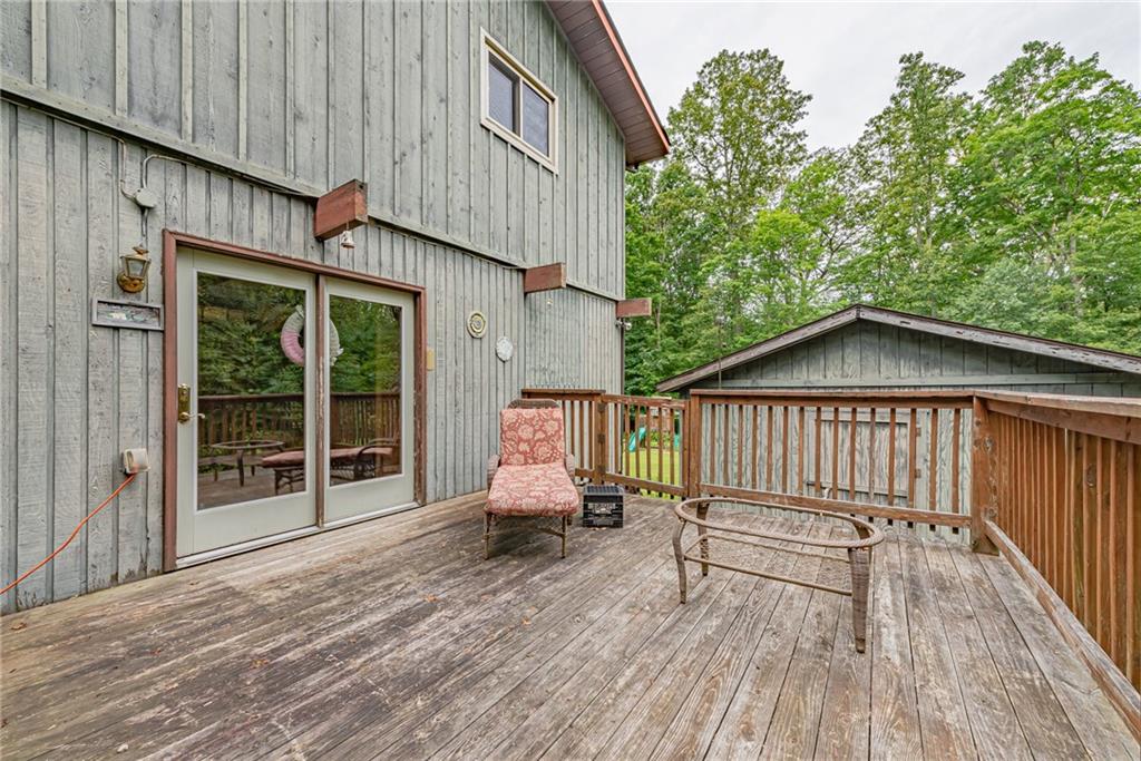 142 Westlake Road Acme, PA 15610 - Photo 11 of 25 a view of backyard with a deck and wooden floor