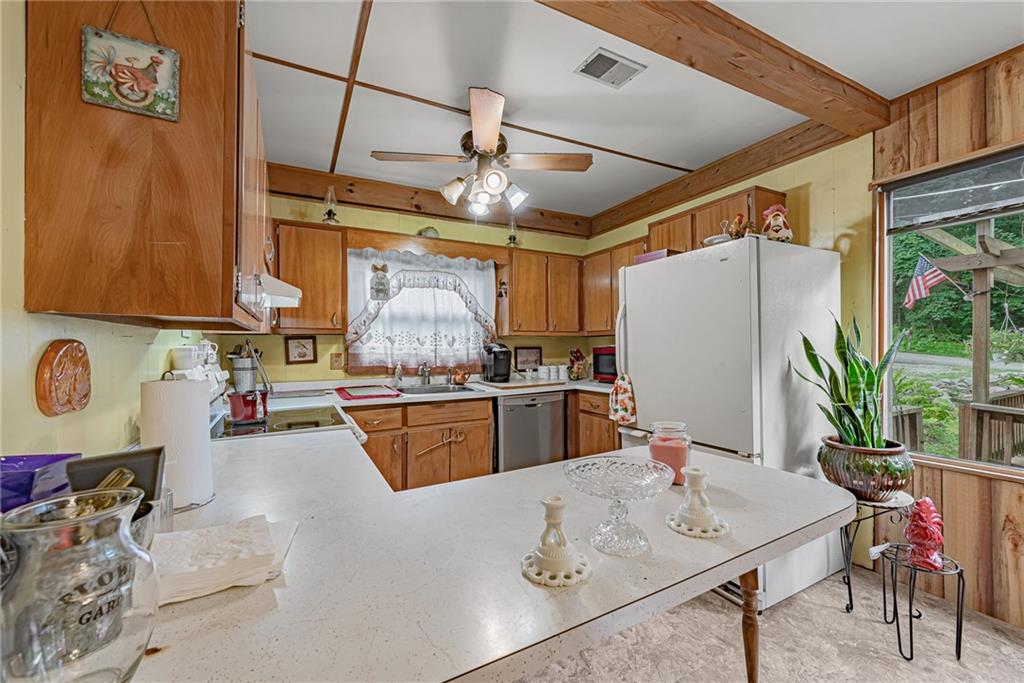 142 Westlake Road Acme, PA 15610 - Photo 12 of 25 a kitchen with stainless steel appliances granite countertop a sink refrigerator and cabinets