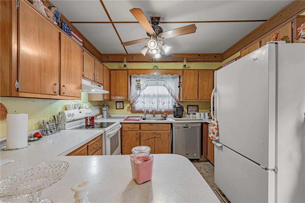142 Westlake Road Acme, PA 15610 - Photo 14 of 25 a kitchen with stainless steel appliances granite countertop a sink window and refrigerator