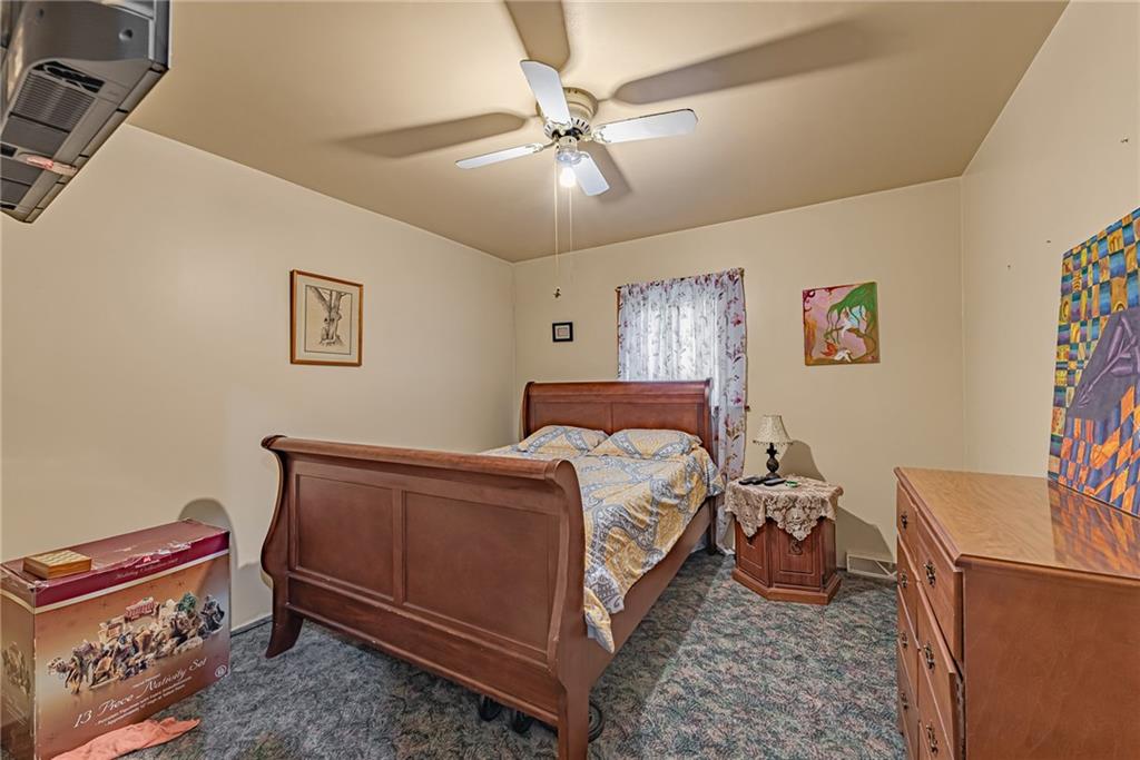 142 Westlake Road Acme, PA 15610 - Photo 23 of 25 a bed room with a bed and a chandelier