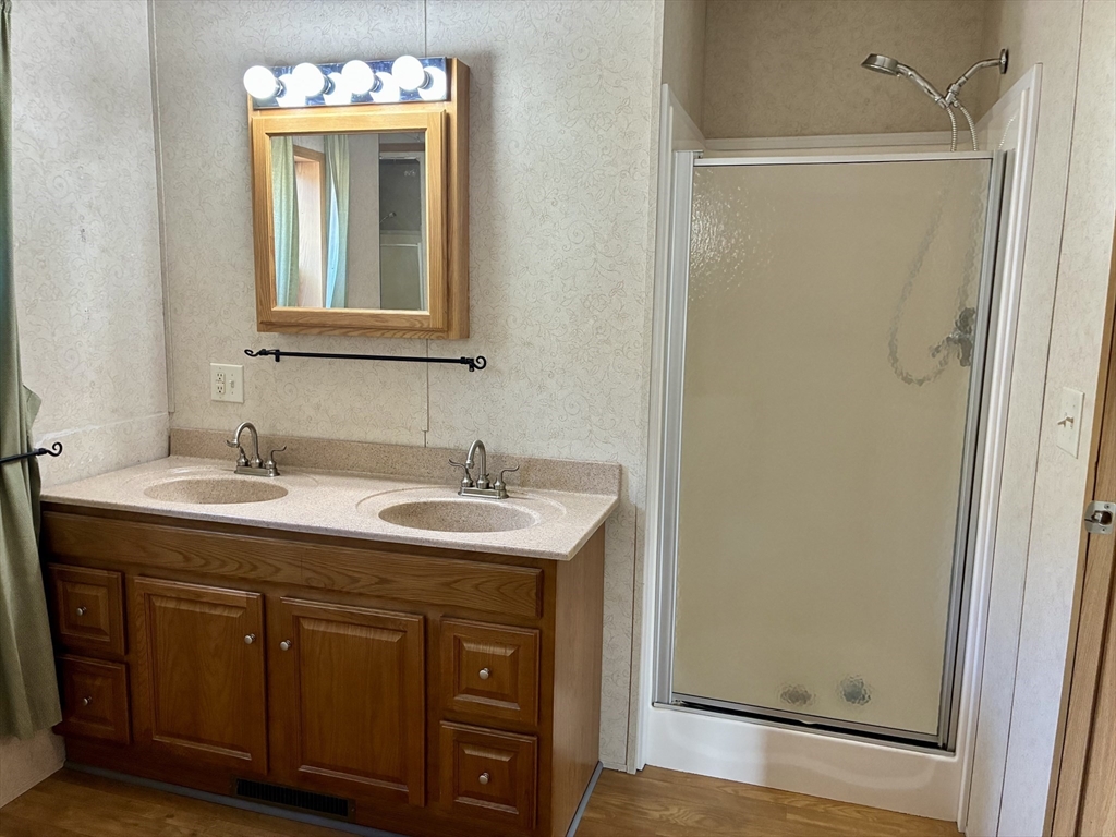559 Tea Street, Unit 9 Charlemont, MA 01339 - Photo 11 of 21 a bathroom with a granite countertop sink and a mirror