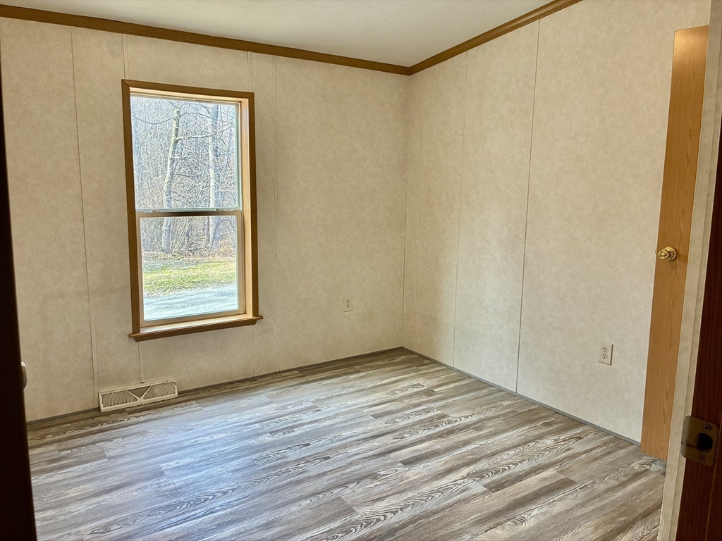 559 Tea Street, Unit 9 Charlemont, MA 01339 - Photo 18 of 21 a view of an empty room with wooden floor and a window