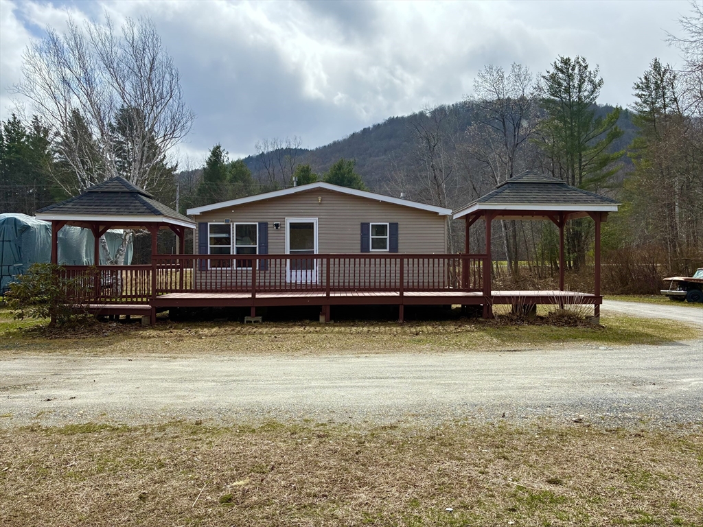559 Tea Street, Unit 9 Charlemont, MA 01339 - Photo 2 of 21 a view of a house with backyard and sitting area