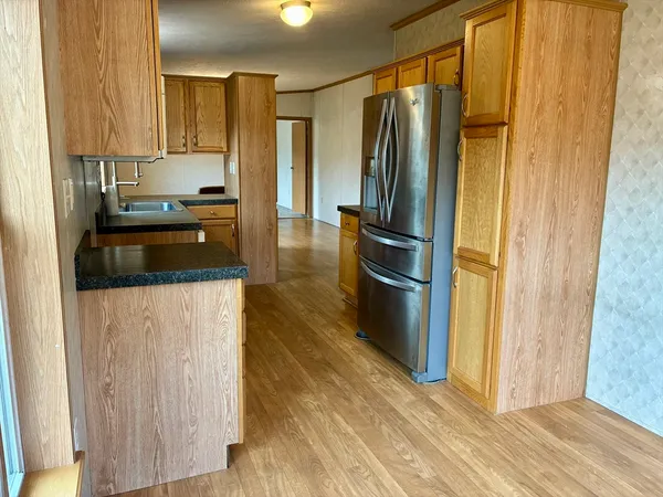 a kitchen with stainless steel appliances a refrigerator and a stove