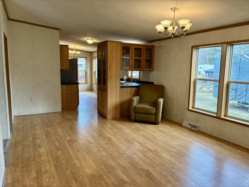 559 Tea Street, Unit 9 Charlemont, MA 01339 - Photo 7 of 21 a view of a livingroom with wooden floor and a ceiling fan