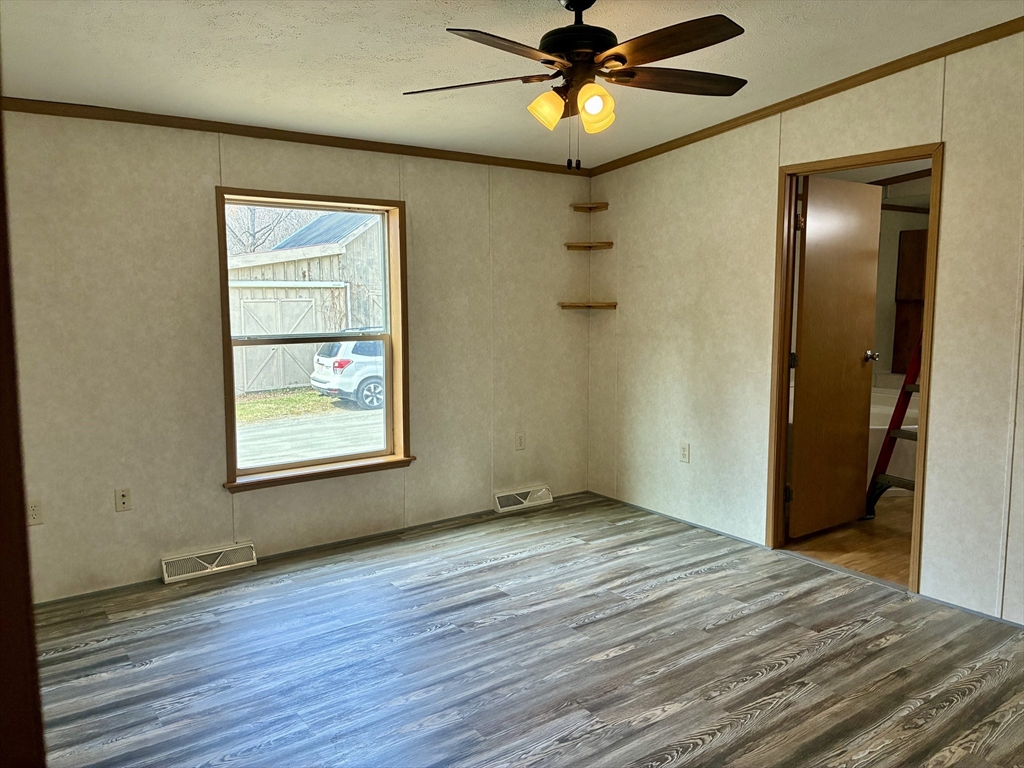 559 Tea Street, Unit 9 Charlemont, MA 01339 - Photo 8 of 21 an empty room with wooden floor closet and windows