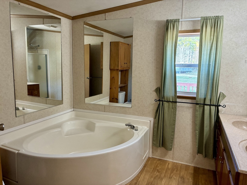 559 Tea Street, Unit 9 Charlemont, MA 01339 - Photo 9 of 21 a white bath tub sitting next to a window