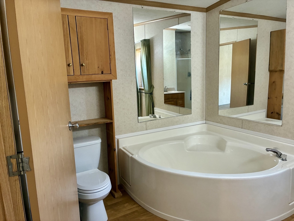 559 Tea Street, Unit 9 Charlemont, MA 01339 - Photo 10 of 21 a white bath tub sitting next to a toilet