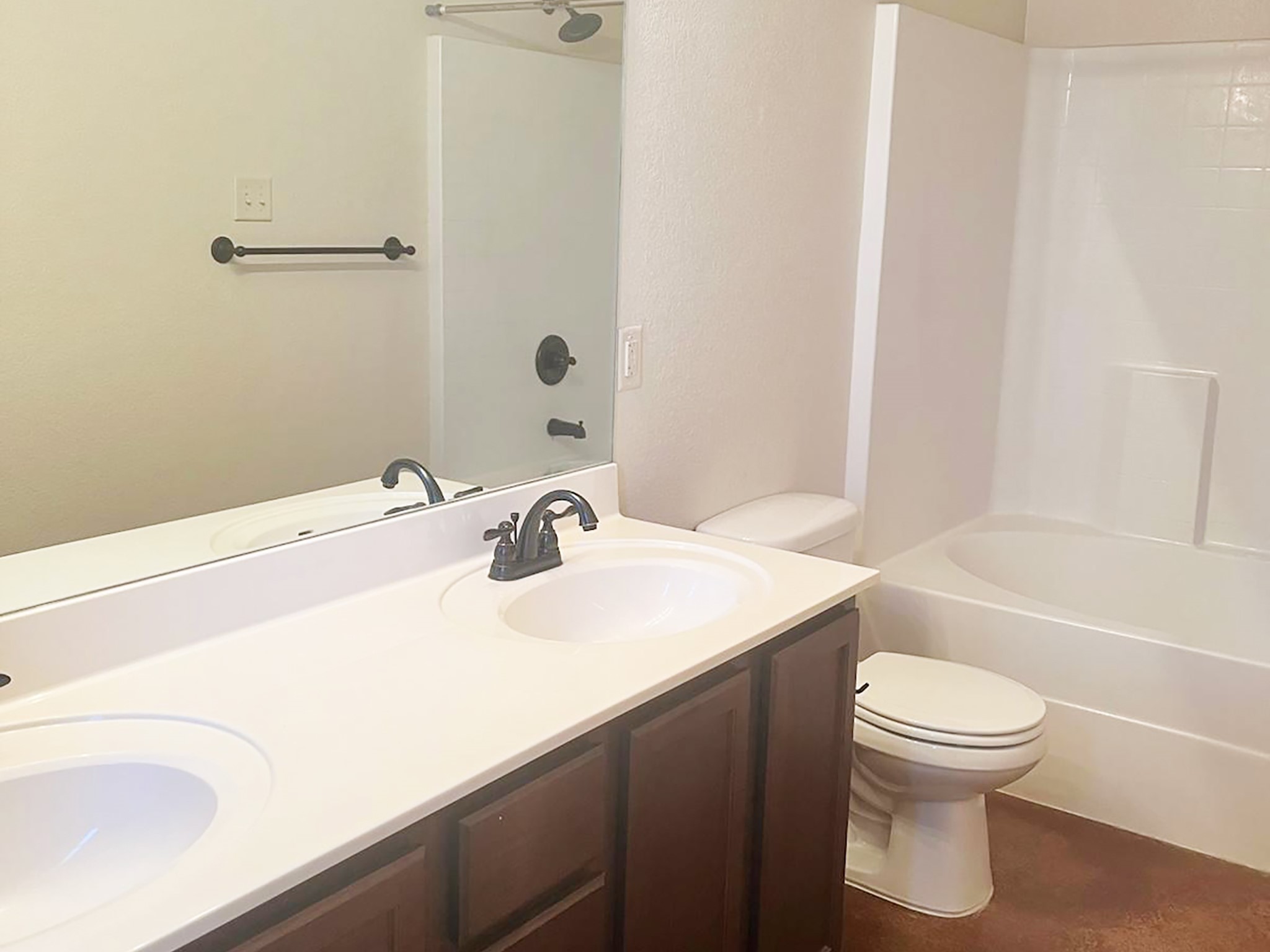 504 Karey Drive Temple, TX 76502 - Photo 16 of 18 Bathroom with double vanity, tub / shower combination, and a textured wall