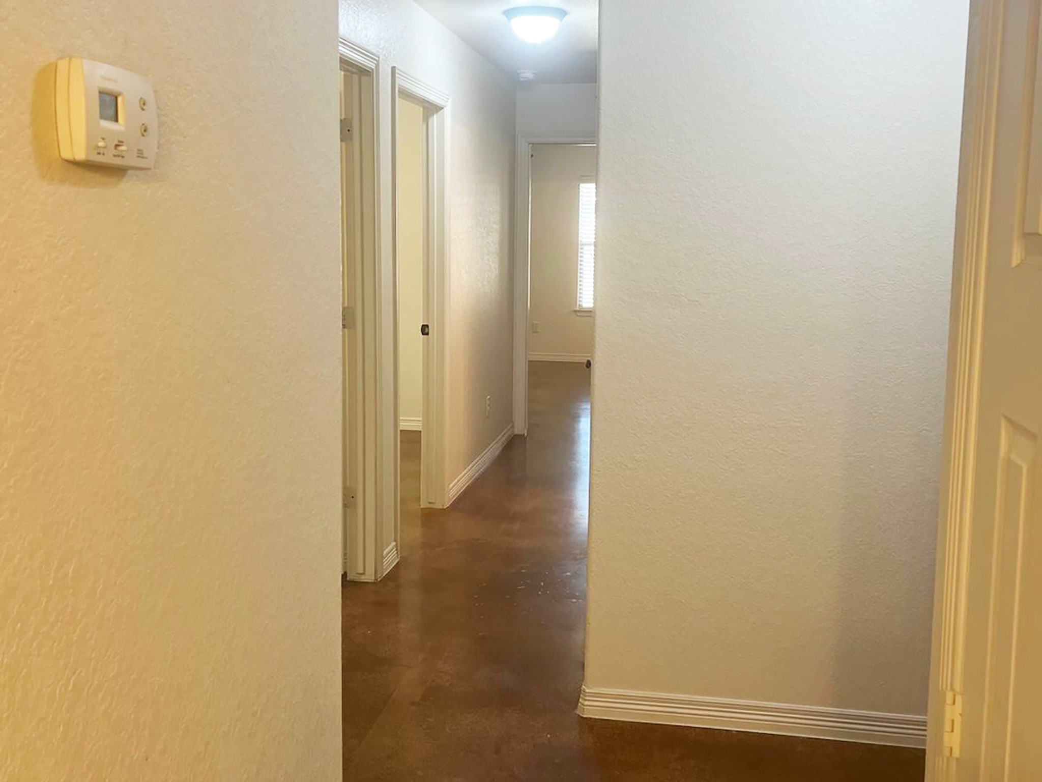 504 Karey Drive Temple, TX 76502 - Photo 7 of 18 Hall with a textured wall and finished concrete floors