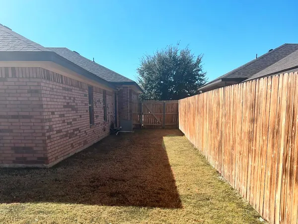 a view of a pathway with a wooden fence
