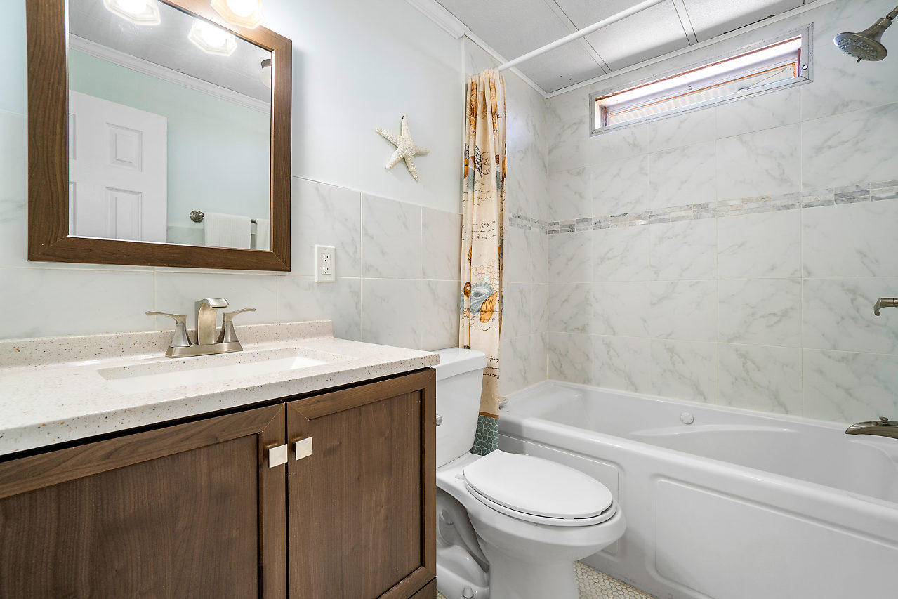 11941 Flotilla Place Boca Raton, FL 33428 - Photo 17 of 21 a bathroom with a granite countertop sink toilet and shower