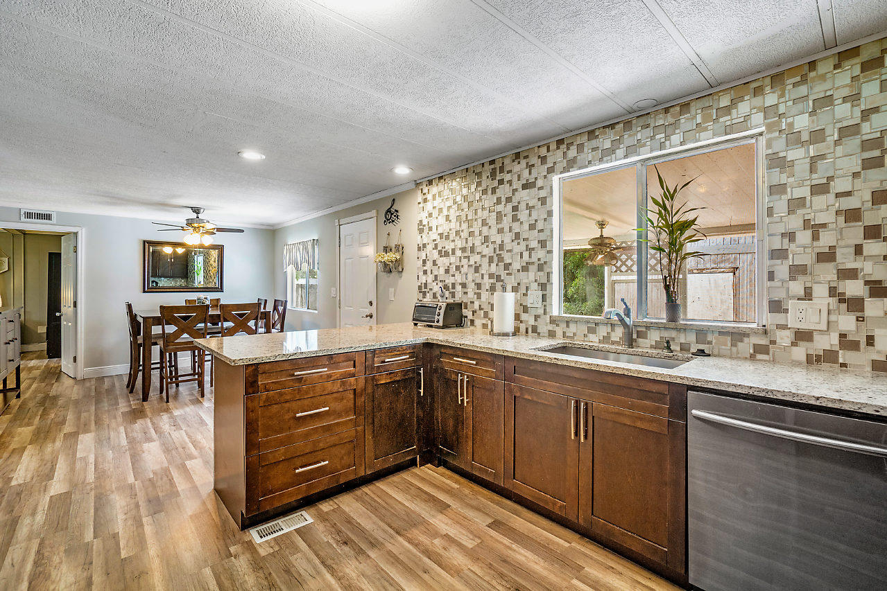 11941 Flotilla Place Boca Raton, FL 33428 - Photo 8 of 21 a kitchen with stainless steel appliances granite countertop a sink and wooden cabinets