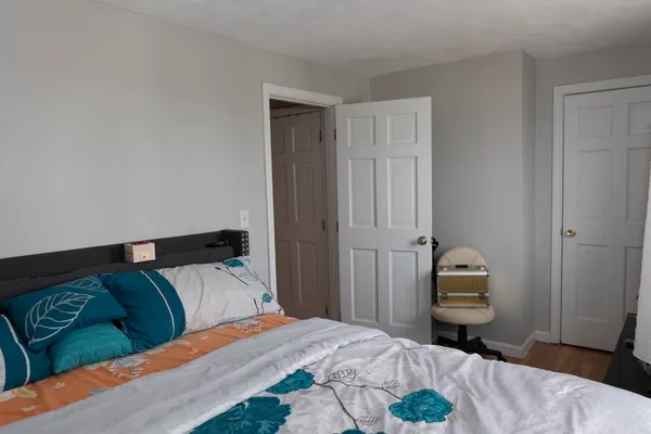a bedroom with a bed and a couch