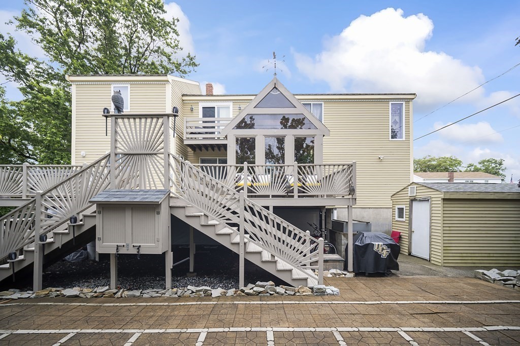 a view of a house with a balcony and car parked