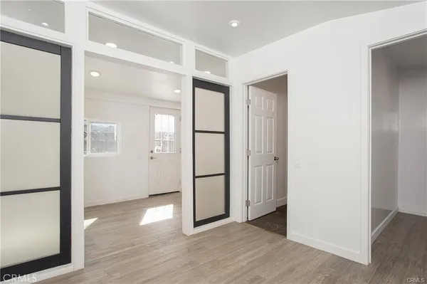 a view of empty room with wooden floor