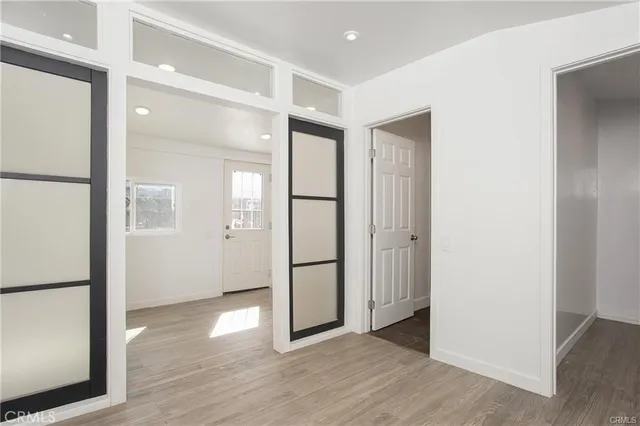 a view of empty room with wooden floor