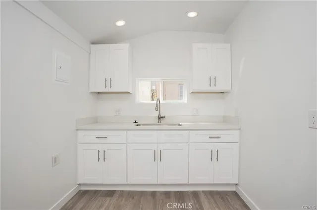 a kitchen with white cabinets