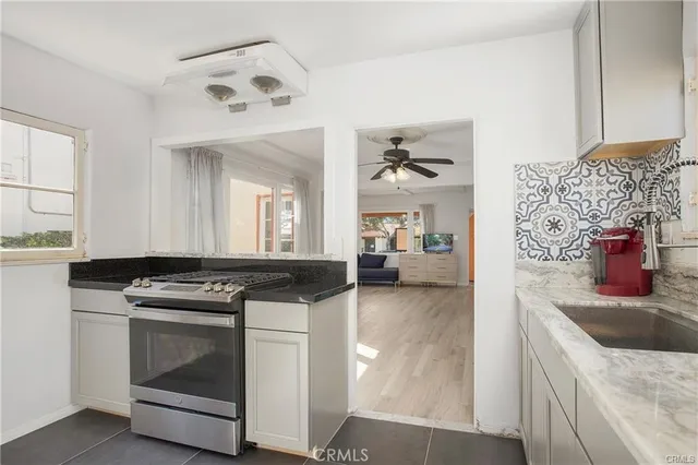 a kitchen with stainless steel appliances granite countertop a stove and a sink
