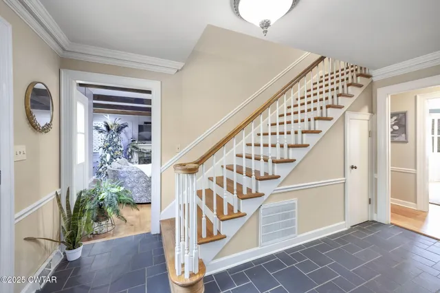 a living room with furniture piano and wooden floor