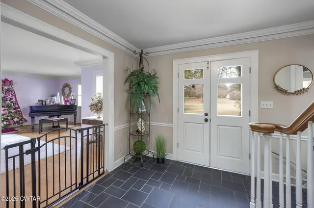 a kitchen with stainless steel appliances granite countertop a stove top oven a sink dishwasher and a refrigerator with wooden floor