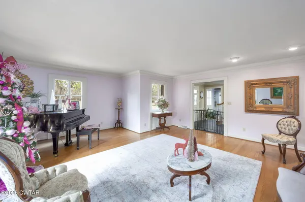 a spacious bedroom with a bed and a flat screen tv