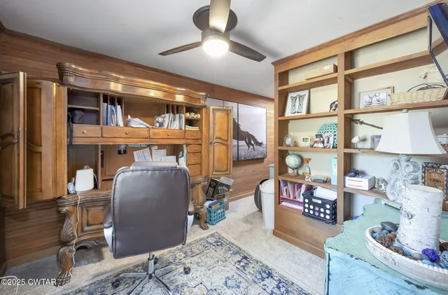 a view of a livingroom with furniture and a hallway