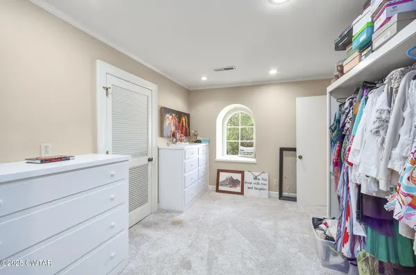 a bedroom with a bed and a television