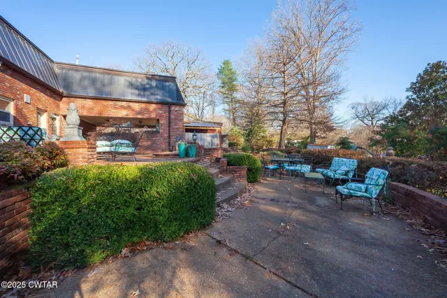a view of yard with swimming pool and green space