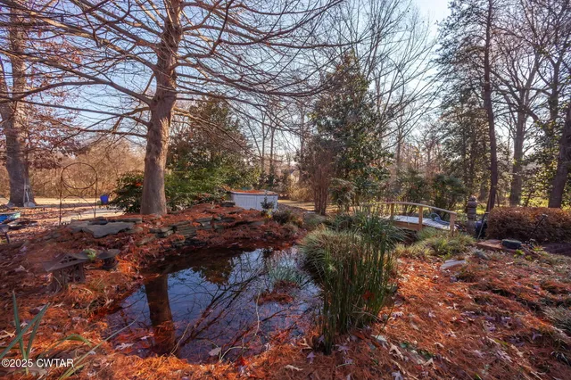 a swimming pool with outdoor seating and yard