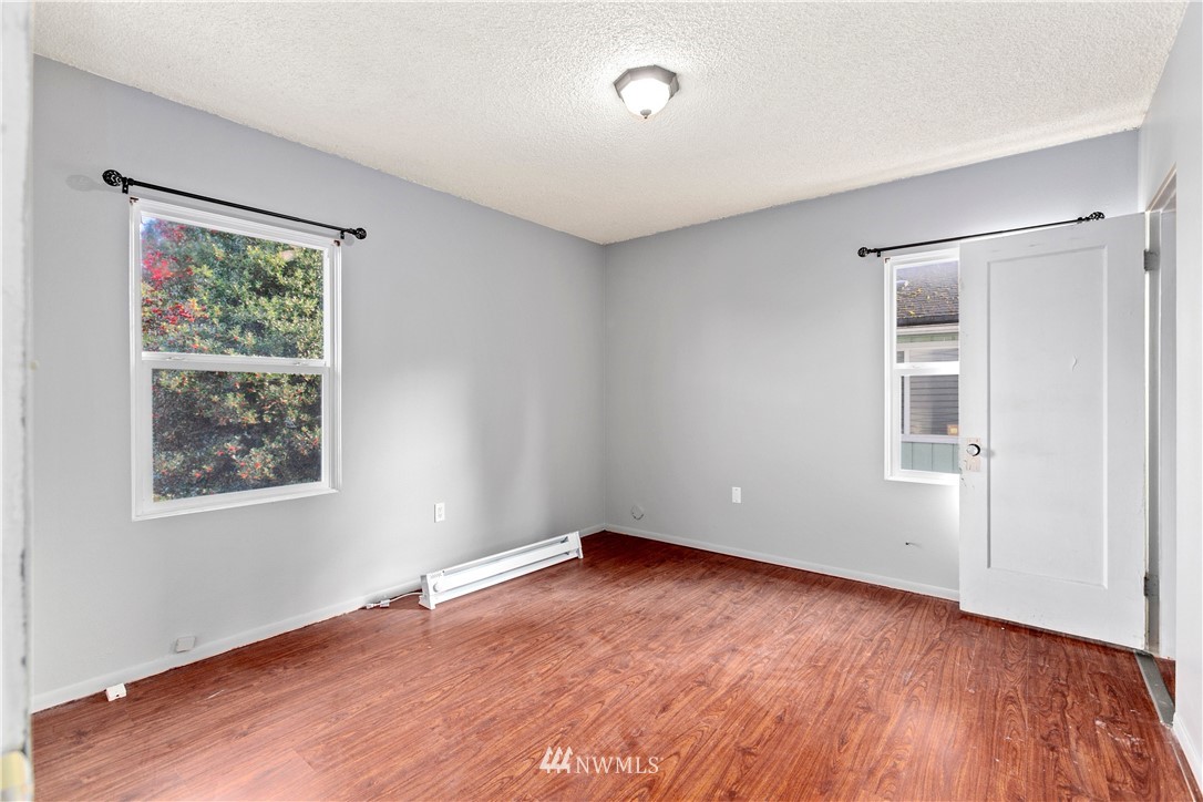 3709 Rockefeller Avenue Everett, WA 98201 - Photo 8 of 12 an empty room with wooden floor and windows