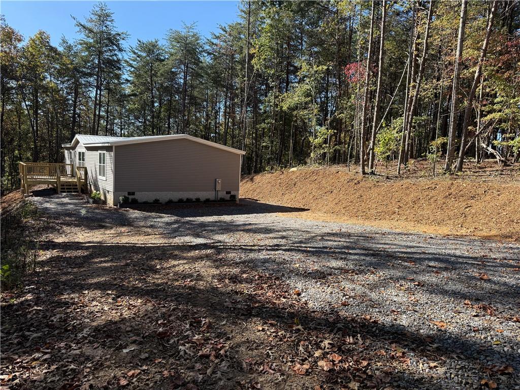 a view of backyard with large trees