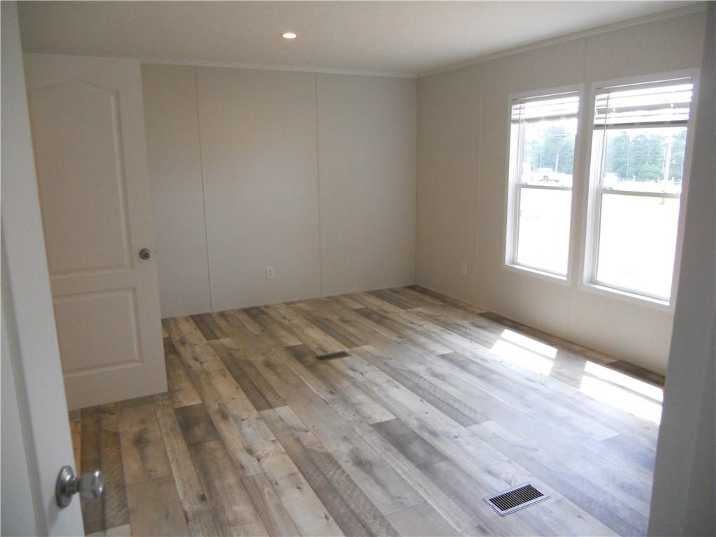 57 Highland Tree Court Ranger, GA 30734 - Photo 25 of 39 a view of empty room with wooden floor and fan