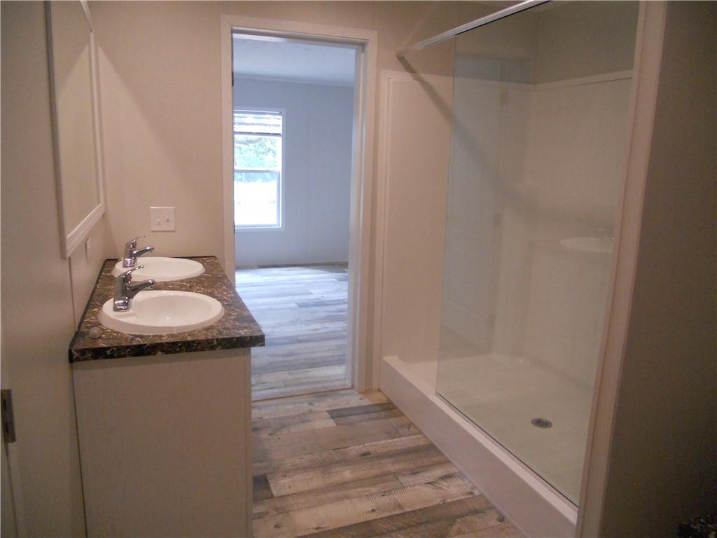 57 Highland Tree Court Ranger, GA 30734 - Photo 29 of 39 a bathroom with a granite countertop sink and a mirror