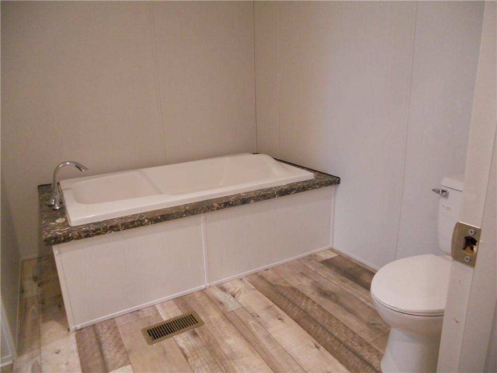 57 Highland Tree Court Ranger, GA 30734 - Photo 30 of 39 a bathroom with a granite countertop sink and a toilet