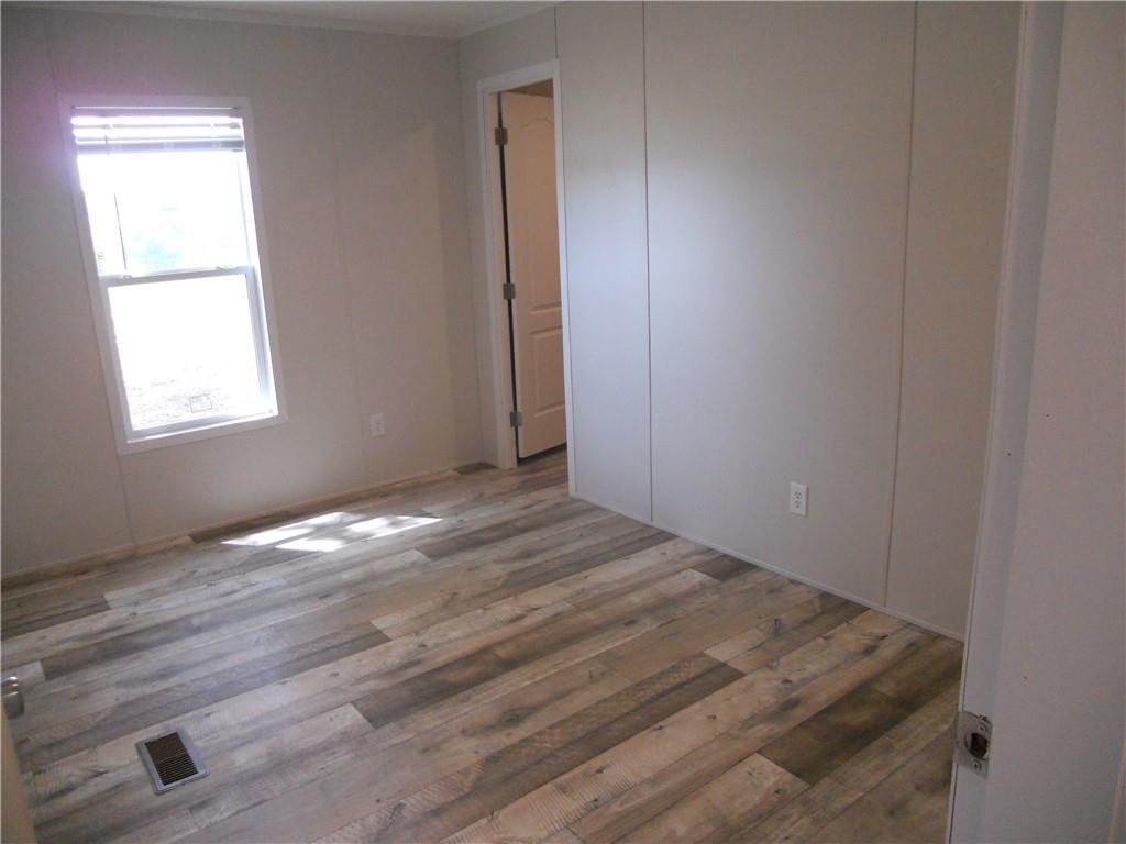 57 Highland Tree Court Ranger, GA 30734 - Photo 32 of 39 an empty room with wooden floor and windows