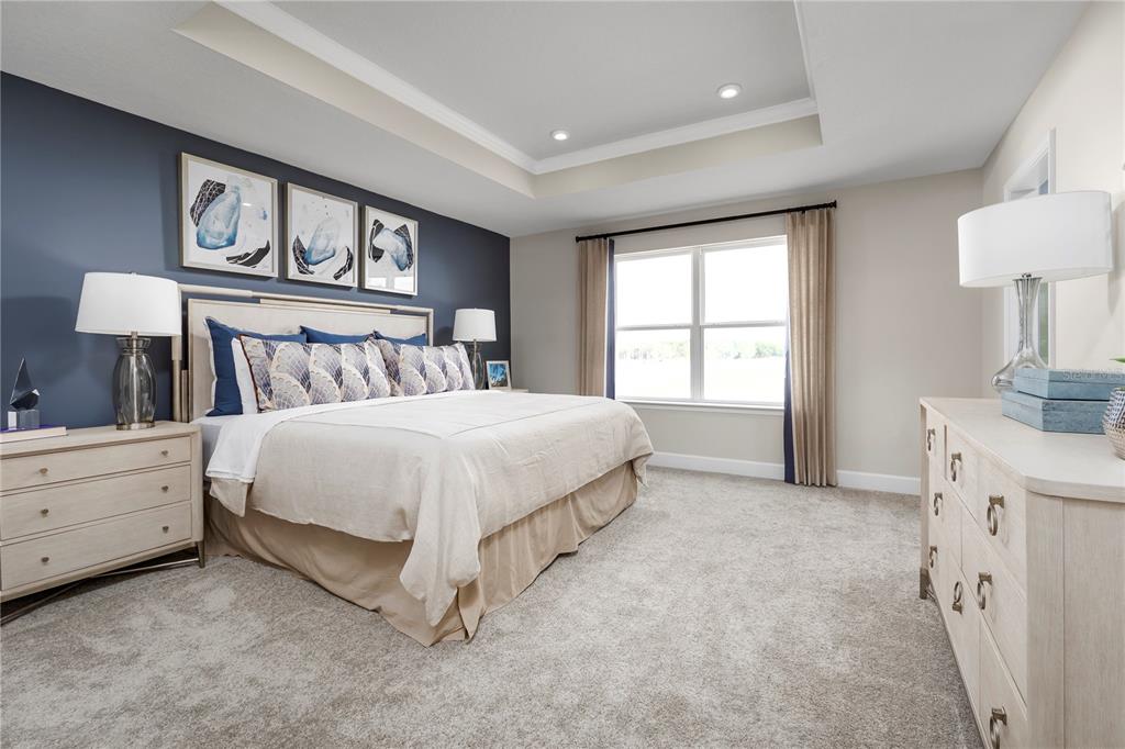 2518 White Ladyfish Road Wimauma, FL 33598 - Photo 14 of 21 a spacious bedroom with a bed and a window