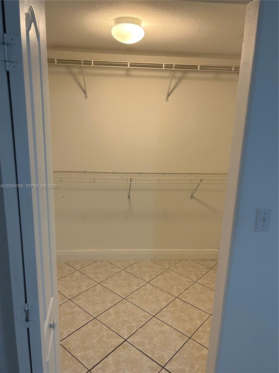 10919 West Okeechobee Road, Unit 101 Hialeah Gardens, FL 33018 - Photo 9 of 21 a view of walk in closet