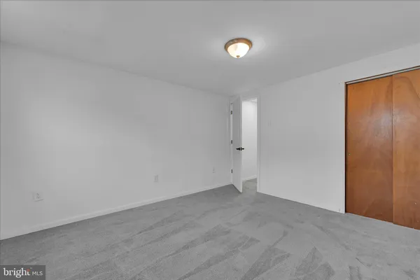 a room with a bed and a television