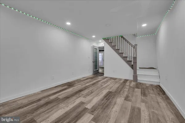 a view of a room with wooden floor and stairs