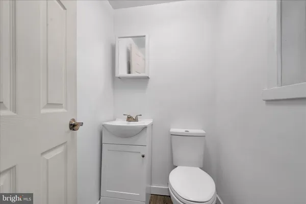 a view of a livingroom with wooden floor and furniture
