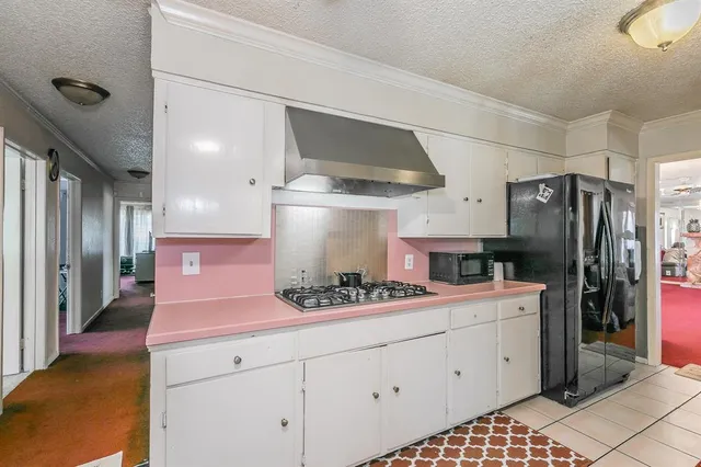 a kitchen with stainless steel appliances a stove a sink and cabinets