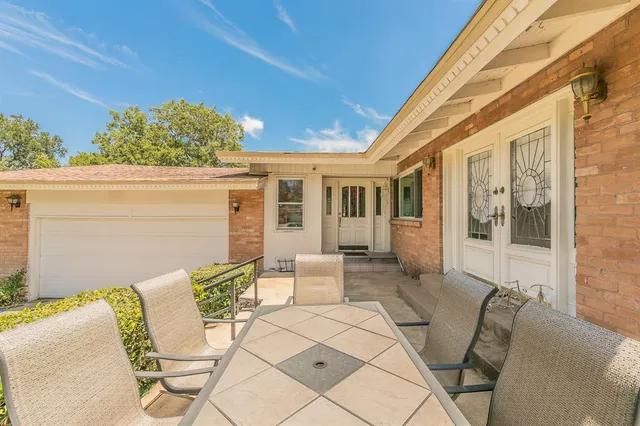a view of a swimming pool and trees in the background