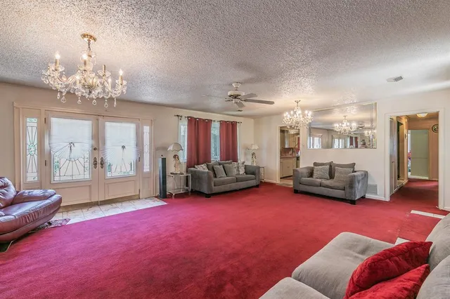 a living room with furniture and a chandelier