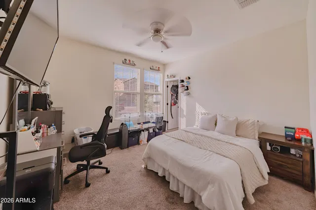 a bedroom with two beds and a desk