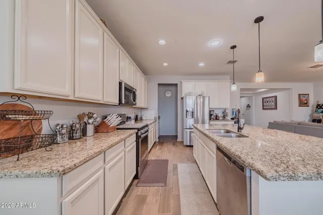 a kitchen with sink stove and cabinets