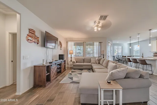 a living room with furniture a flat screen tv and a fireplace